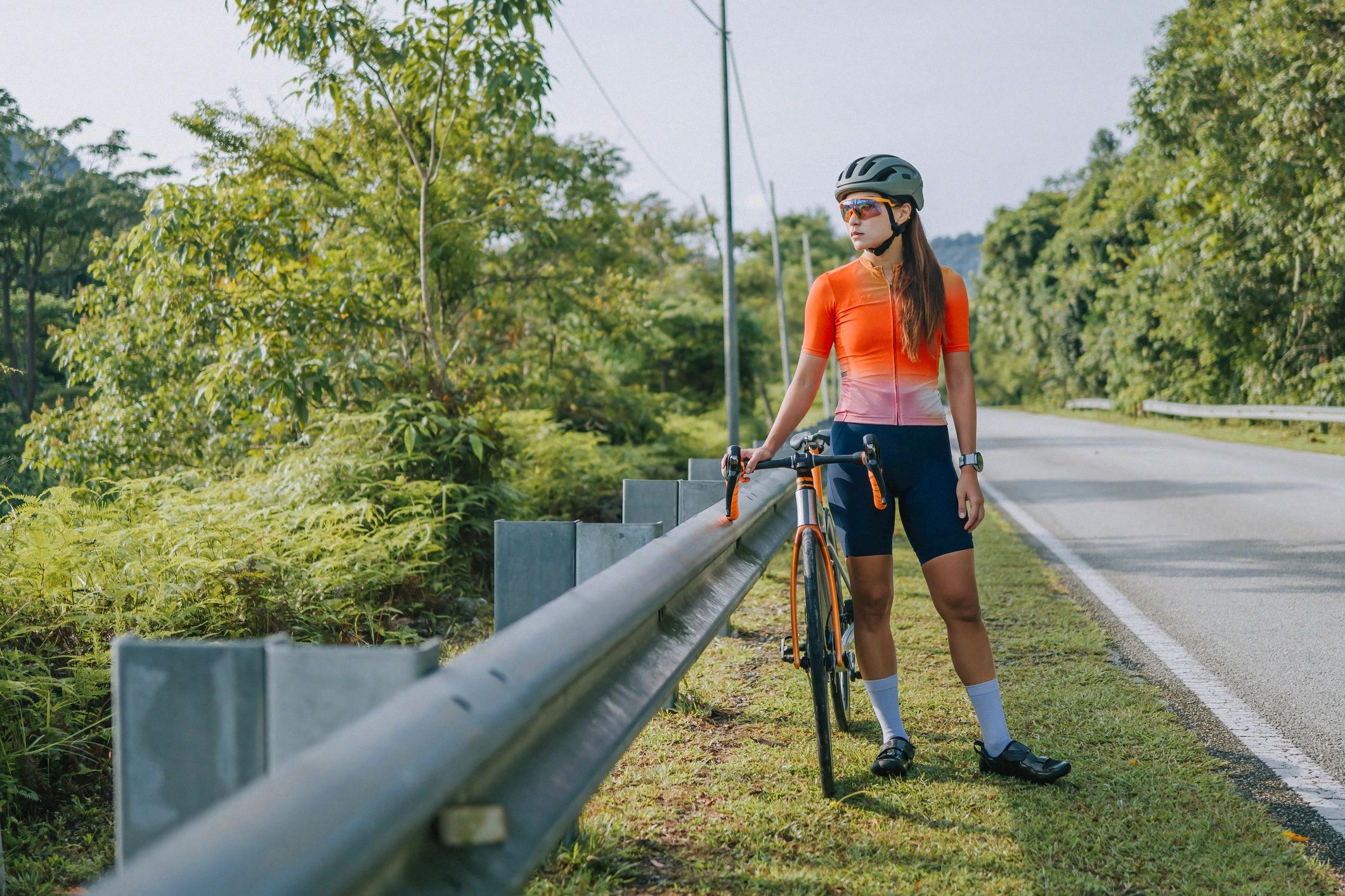 Road cyclist training outdoors with focused expression